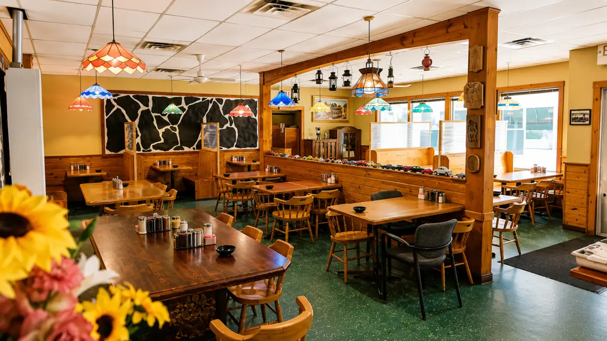 Top Notch dining room with wood tables, colourful pendant lights and retro details